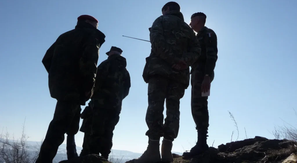 KFOR officers on a ridge in Kosovo